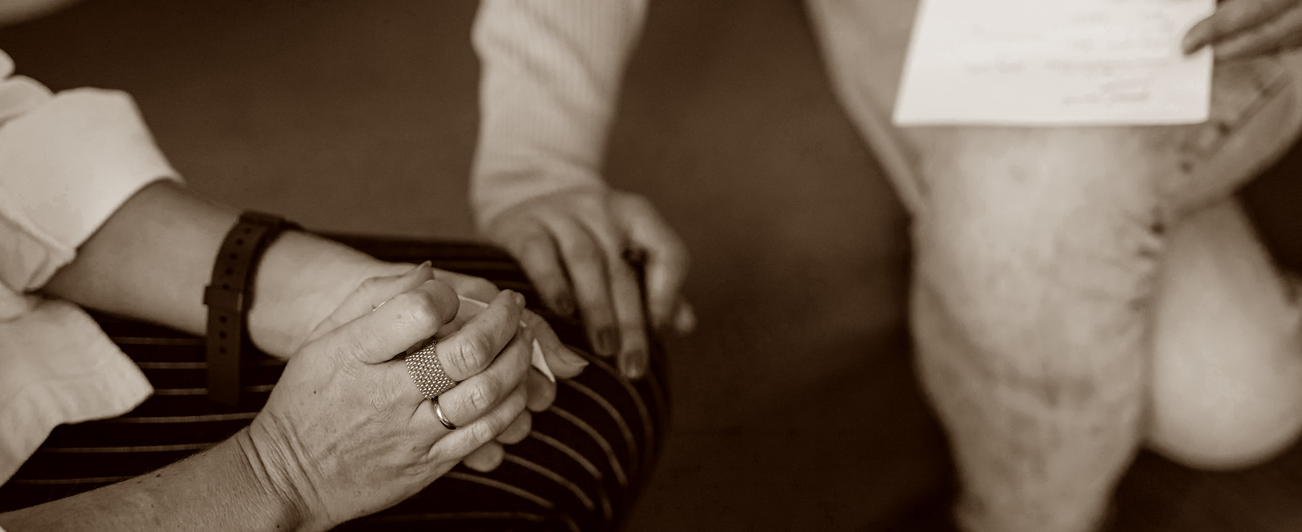 A professional putting their hand on their client who is in distress.