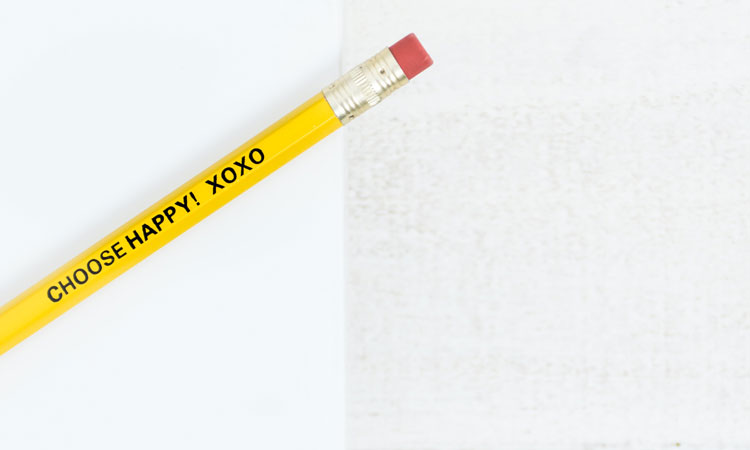 Yellow pencil with the words "Choose Happy" printed on it