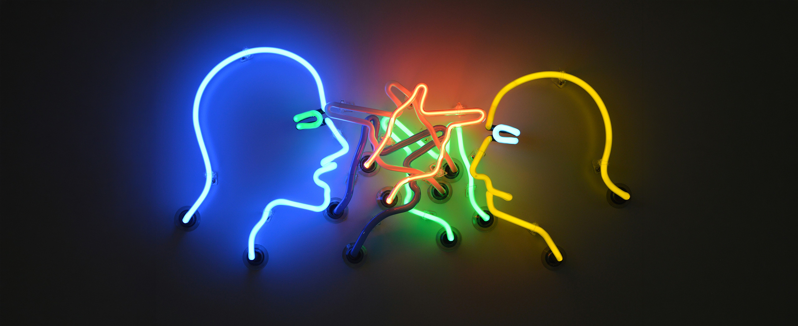 A neon sign of two people arguing. 