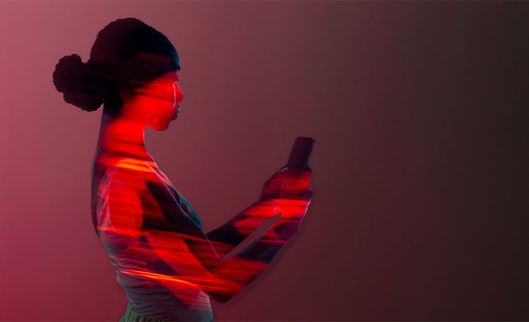 A woman looking at her smart phone.