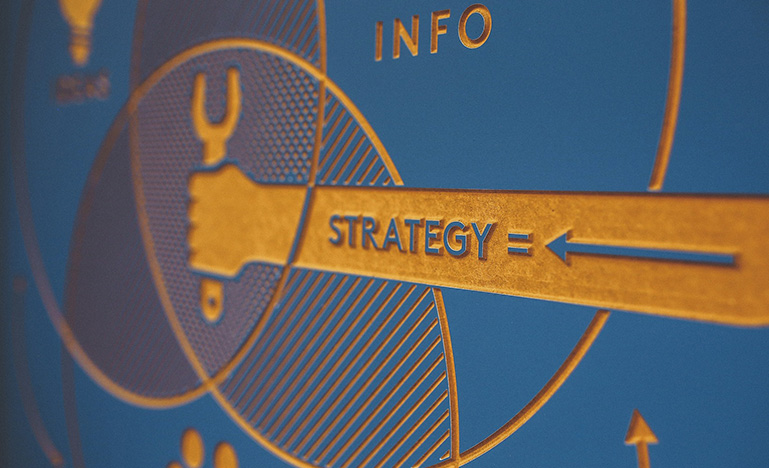 Carved graphic with "strategy" at the centre of a set of interlocking circles