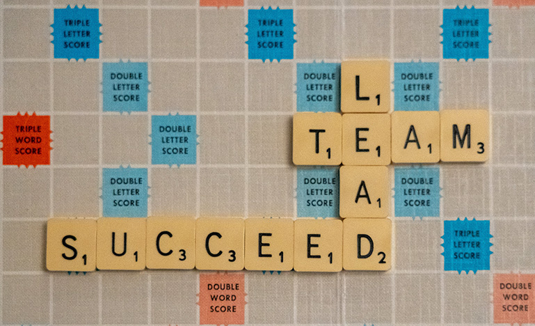 Scrabble board with the words "success", "lead" and "team" spelled out
