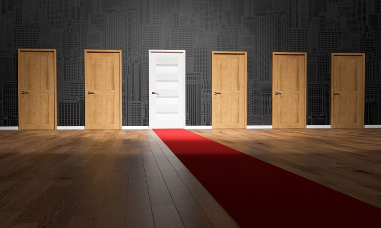 A red carpet leading up to a single white door in the middle of a row of brown doors