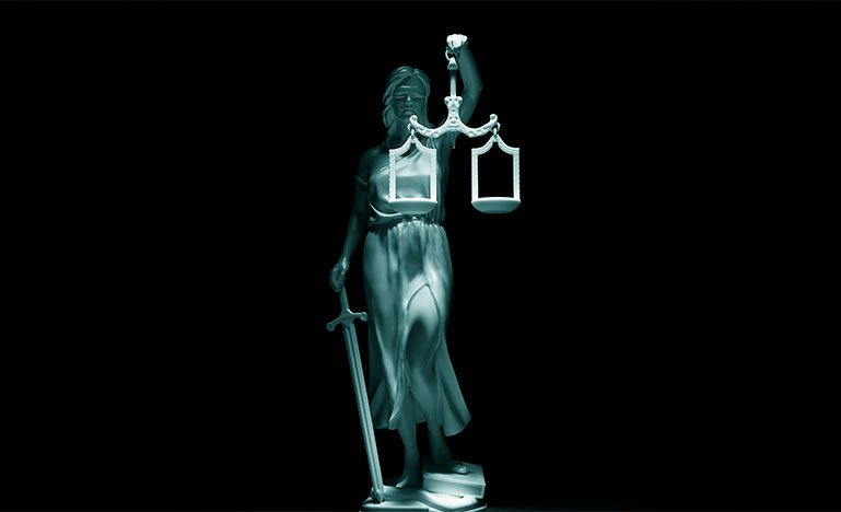 The scales of justice on a dark background