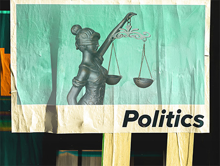 A street poster with the scales of justice and "Politics" on it.
