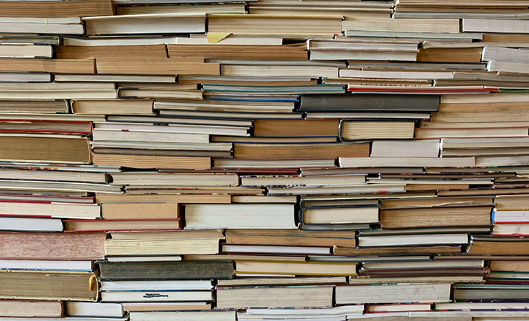 A tightly stacked collection of books.