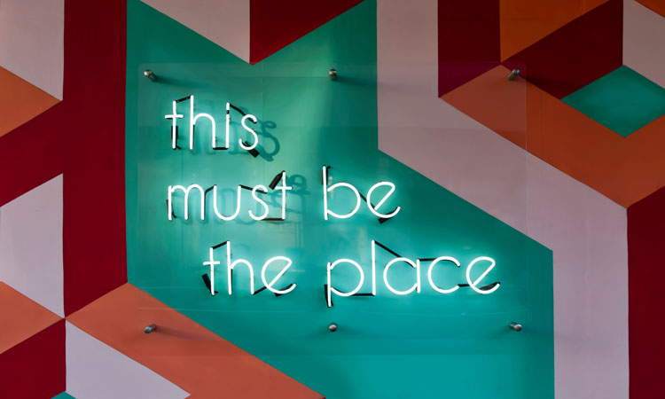 Neon sign of the words "This Must Be The Place"