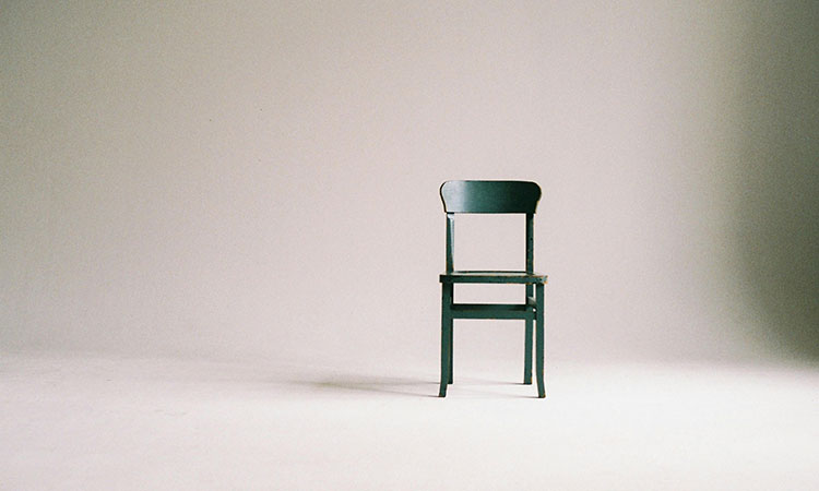 Green chair in white room