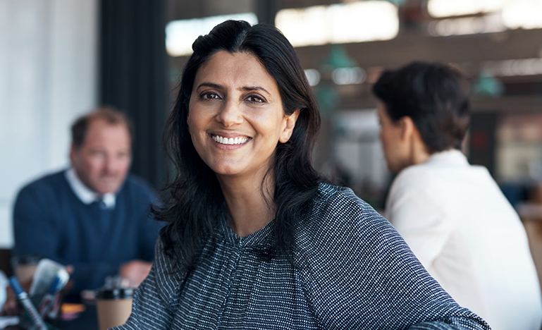 A professional woman looking directly into the camera.