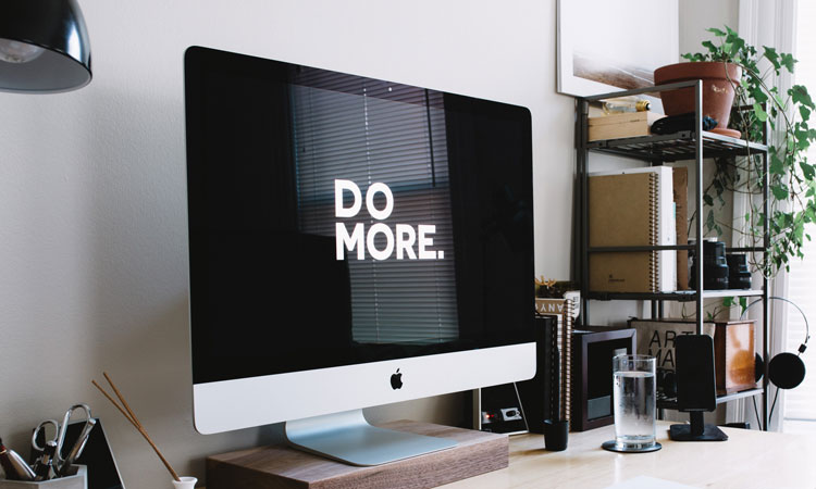 The words "do more" in white font on a black computer monitor screen