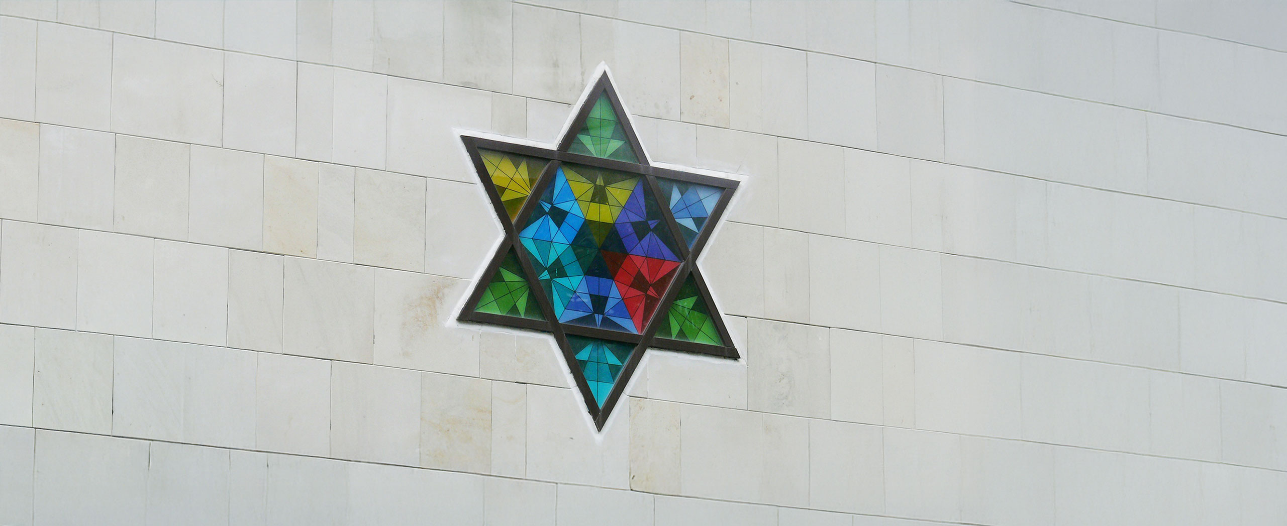 A stain glass window of the Star of David.