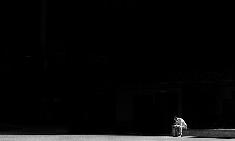 Man sitting by himself on a bench