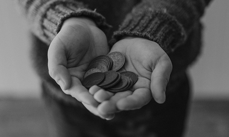 Two hands cupping together holding coins