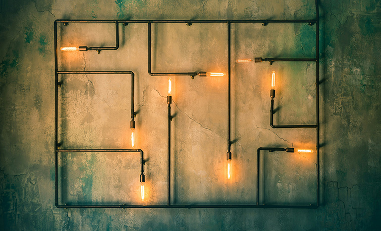 A maze of pipes with lights on the ends depicting auto decision making.