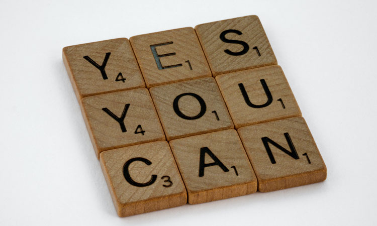 The words "Yes" "You" and "Can" spelled out in scrabble letters