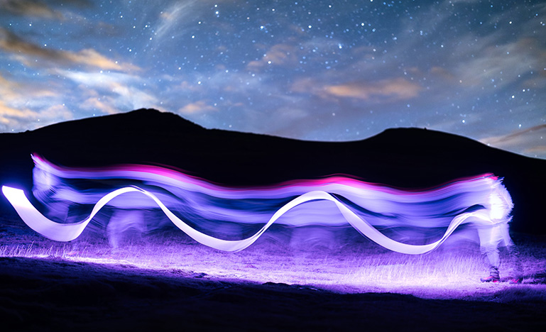 Purple squiggle line created by the long exposure of a purple light