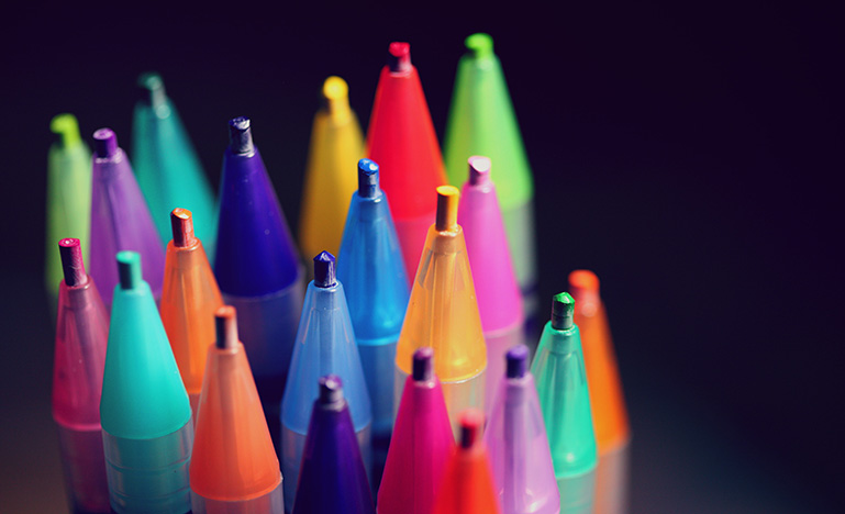 Pencil crayons in assorted colours pointing up 