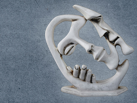 An abstract sculpture of two people in a close embrace.
