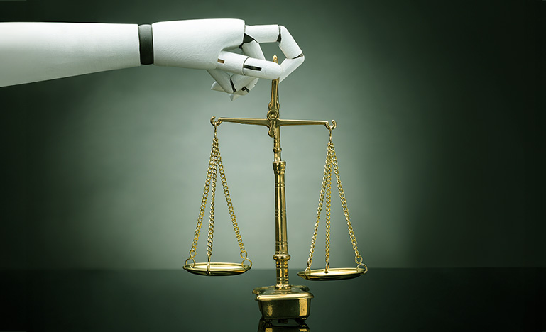 A robot arm holding the scales of justice.