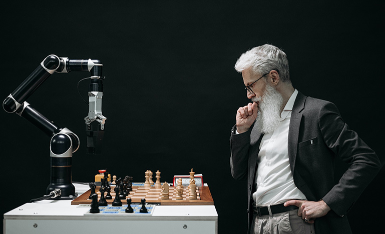 Person playing chess with a robot