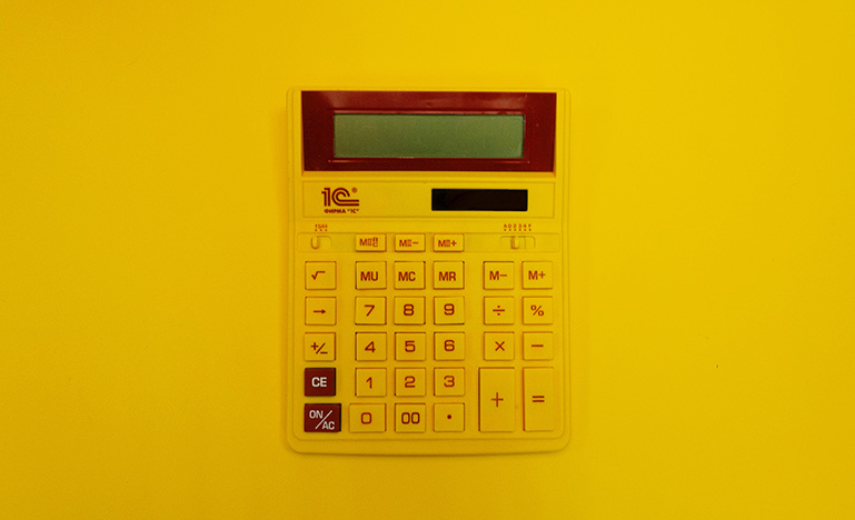 Yellow calculator on a yellow background