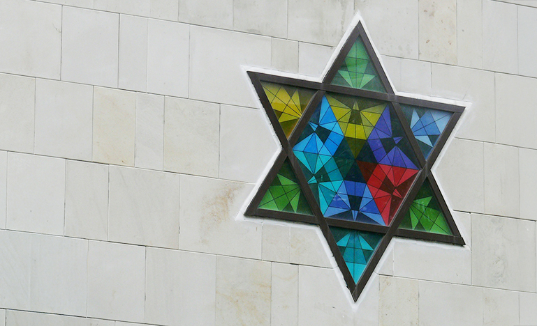 A stain glass window of the Star of David.