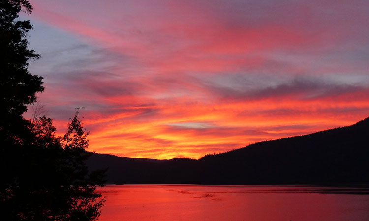 Red and yellow sunset reflected in a lake