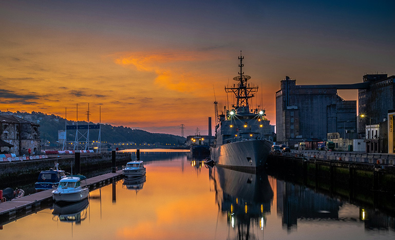 a large ship docked at a shipping yard