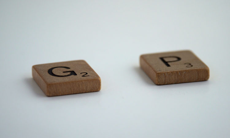 Two scrabble times with the letters G and P with a space between them