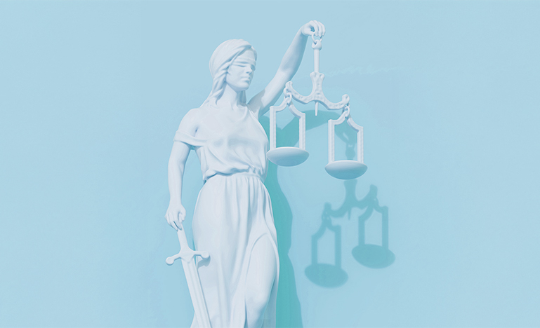 The goddess Themis holding the scales of justice and a sword.