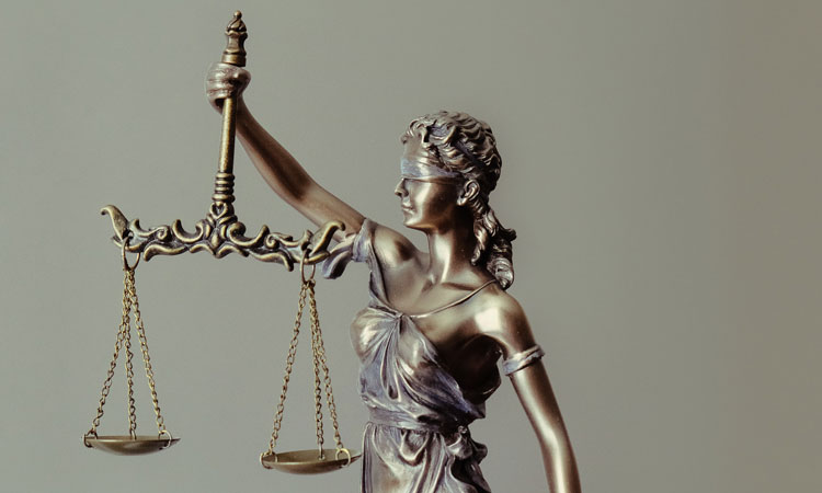 Mental statue of a person holding balancing scales