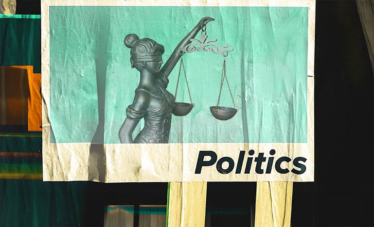A street poster with the scales of justice and "Politics" on it.