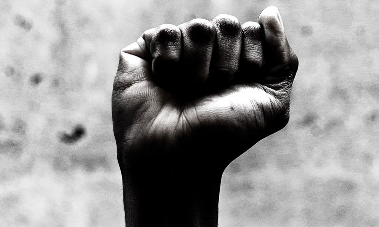 Dark skinned person's hand formed into a fist