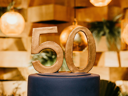 A large "50" figure on top of a podium.