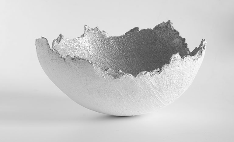 Half a broken egg shell on a white table